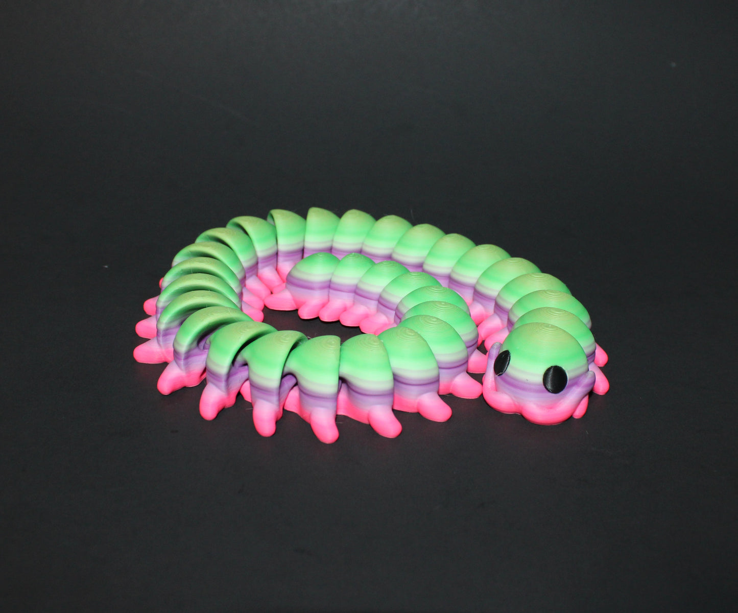 A 3D-printed centipede, measuring 18.5 inches in length, with each piece showcasing a one-of-a-kind rainbow pattern!