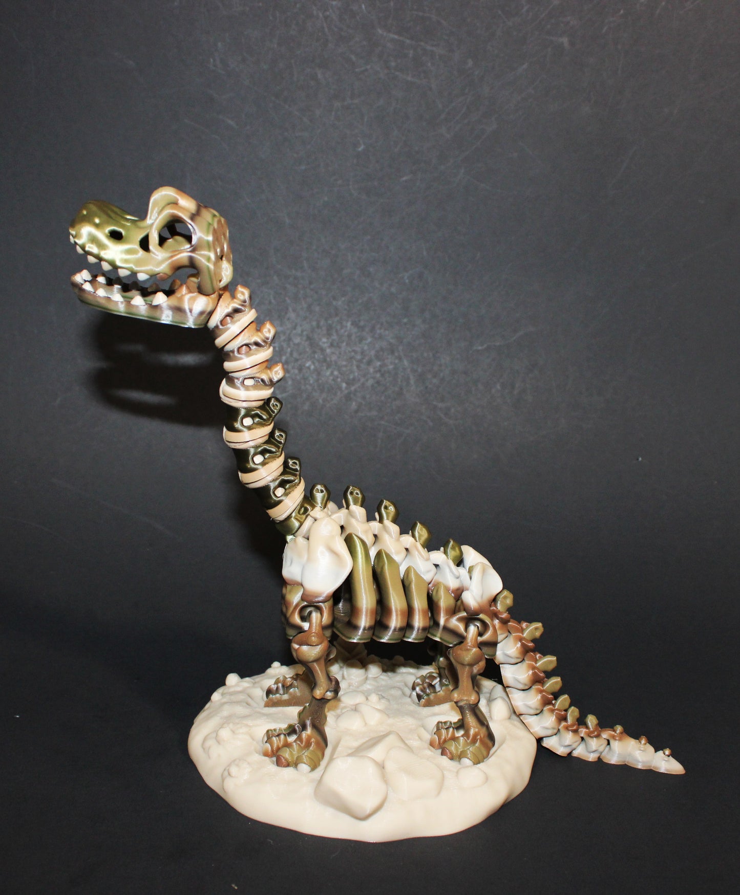 A 3D-printed articulated Brachiosaurs skeleton includes a stand and branch. 7.5" Tall