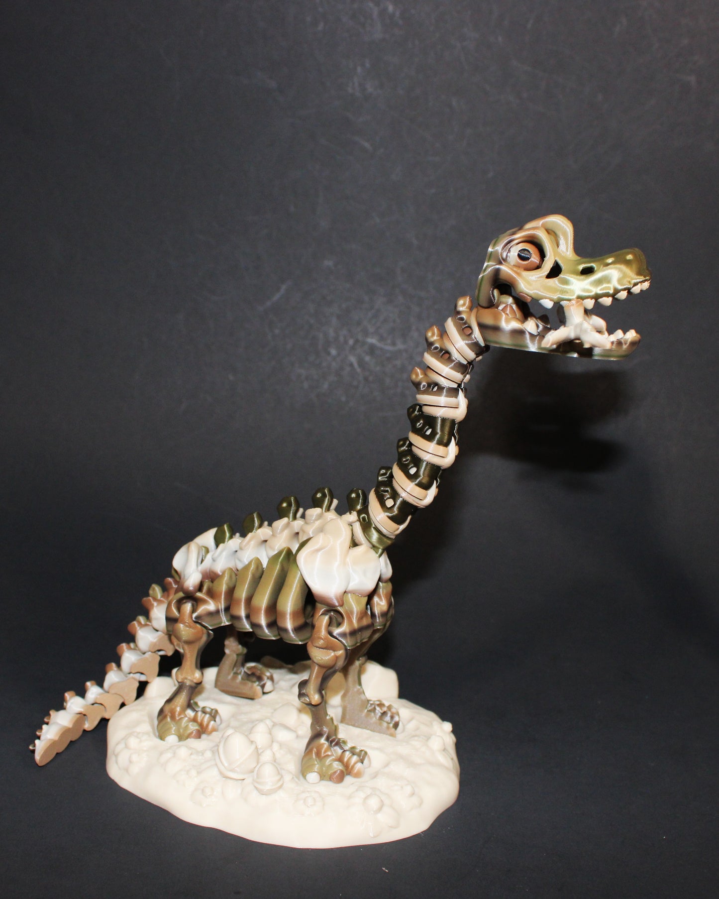 A 3D-printed articulated Brachiosaurs skeleton includes a stand and branch. 7.5" Tall