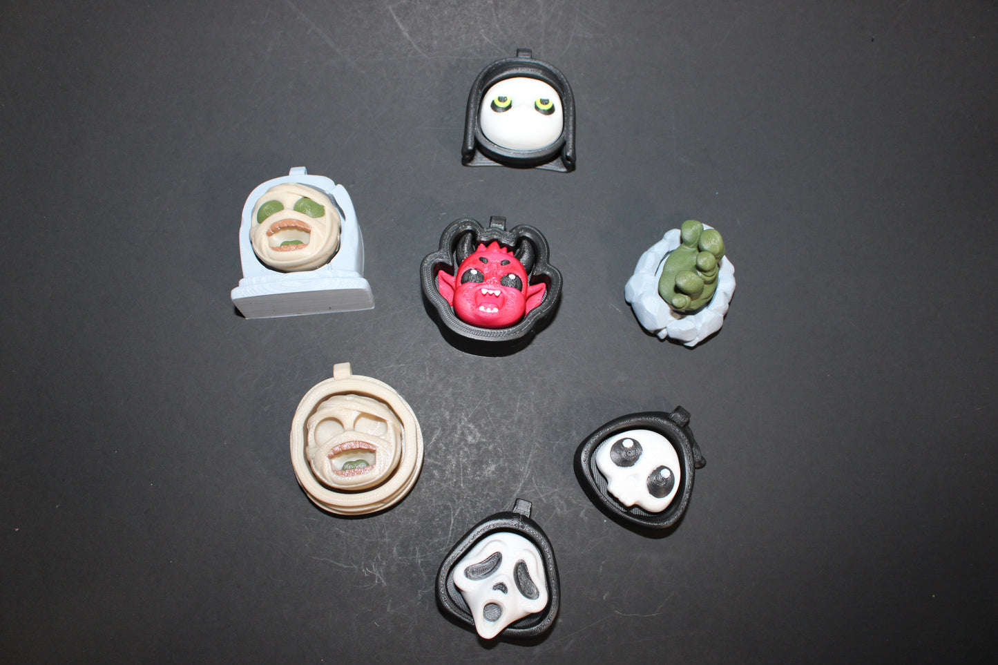 3D-printed Halloween keychain clickers, 2 inches.