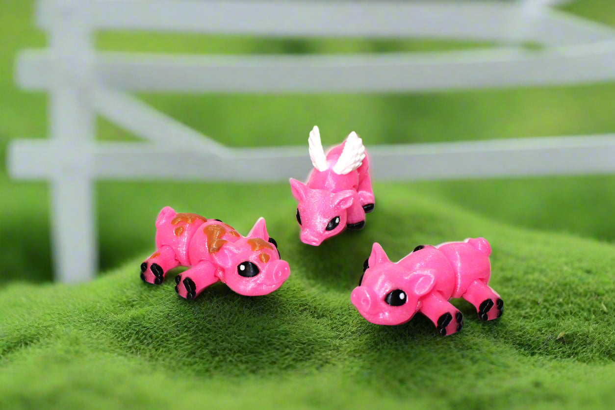 Three pink toy triceratops on a white background with green leaf patterns.