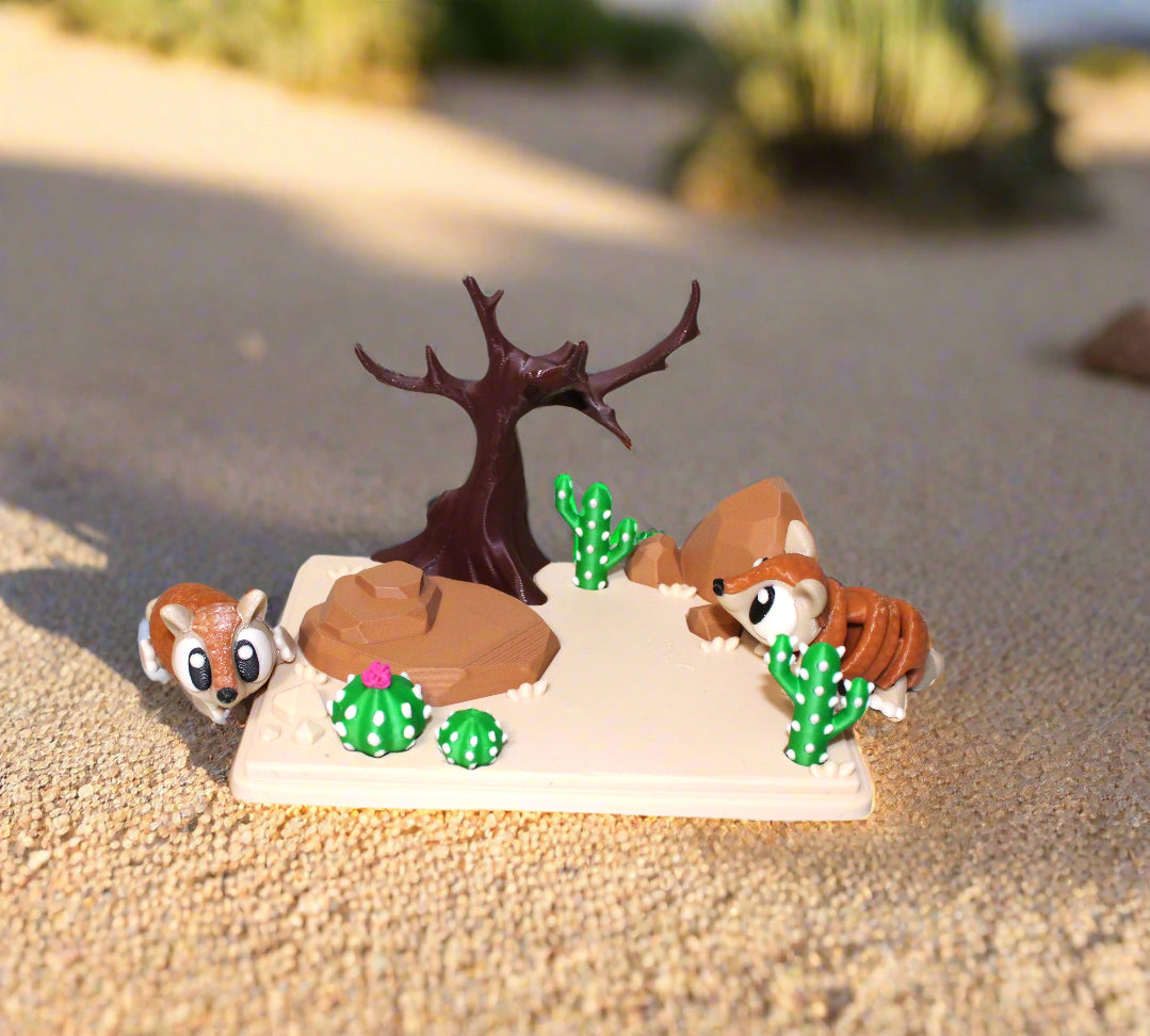 Small desert-themed diorama with animals and plants on a white background
