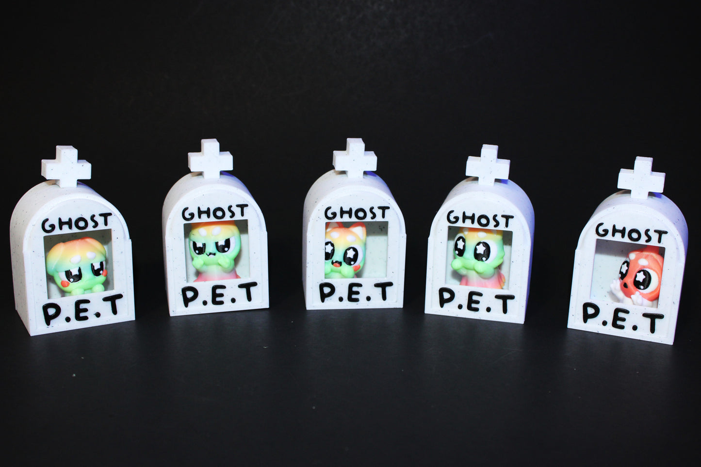 3D-printed glow-in-the-dark or blacklight ghost pets, complete with a tombstone accessory. - Wonderland 3D Printing