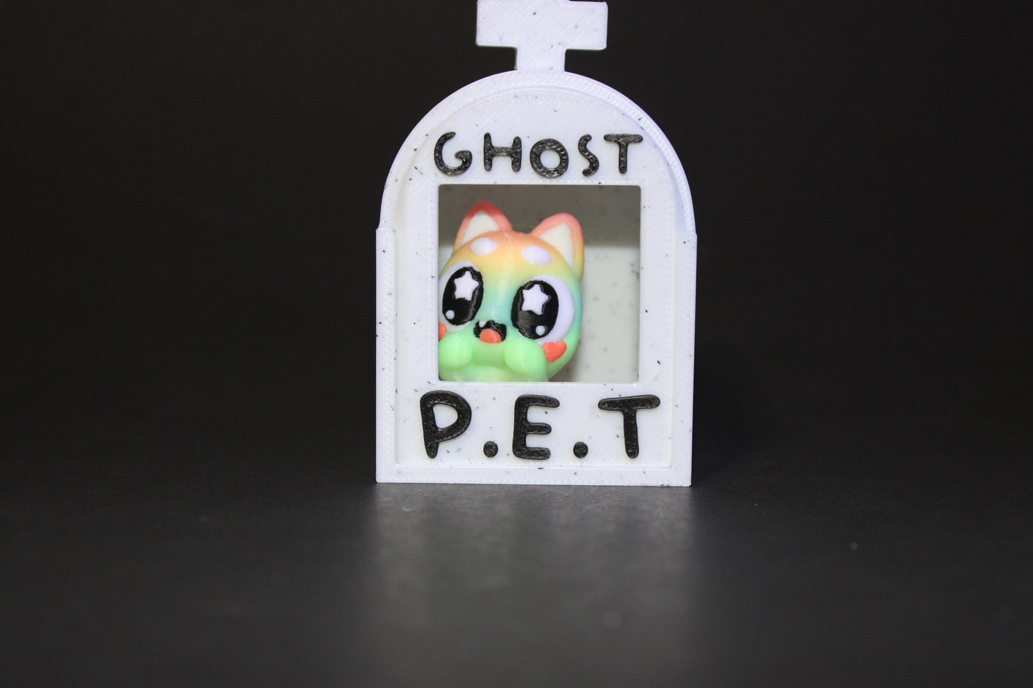 3D-printed glow-in-the-dark or blacklight ghost pets, complete with a tombstone accessory. - Wonderland 3D Printing
