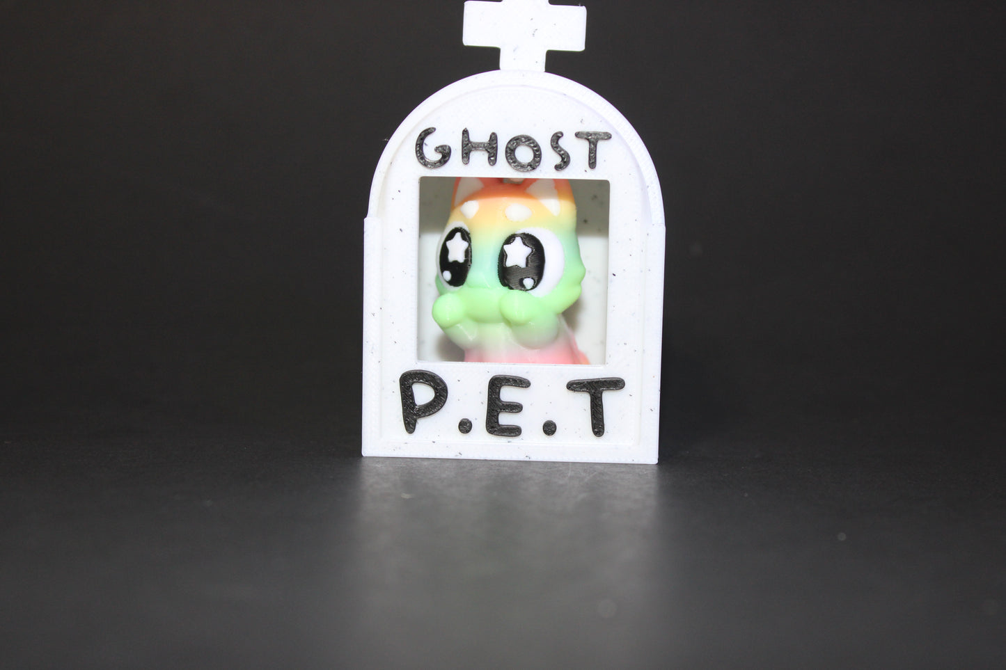 3D-printed glow-in-the-dark or blacklight ghost pets, complete with a tombstone accessory. - Wonderland 3D Printing
