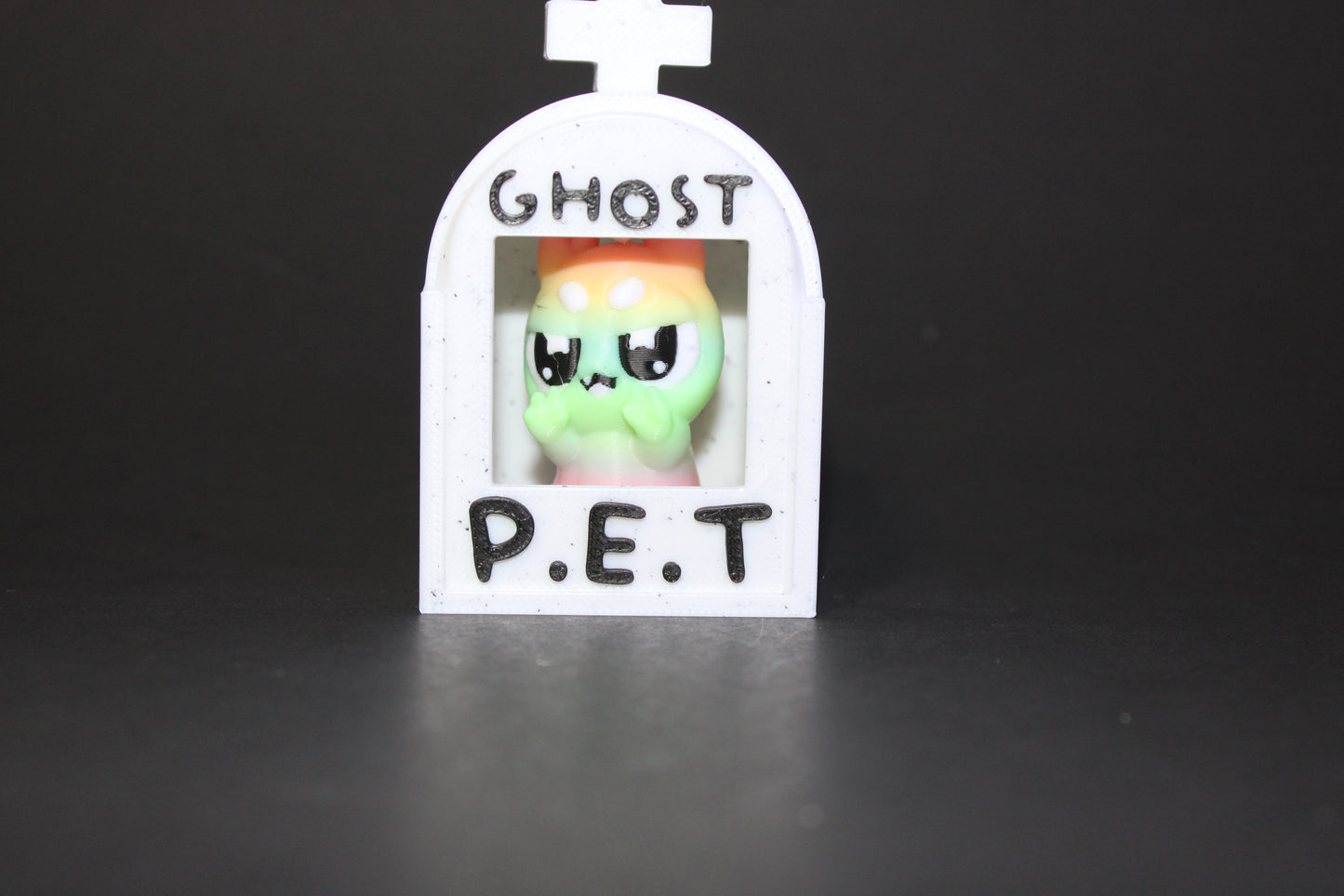 3D-printed glow-in-the-dark or blacklight ghost pets, complete with a tombstone accessory. - Wonderland 3D Printing