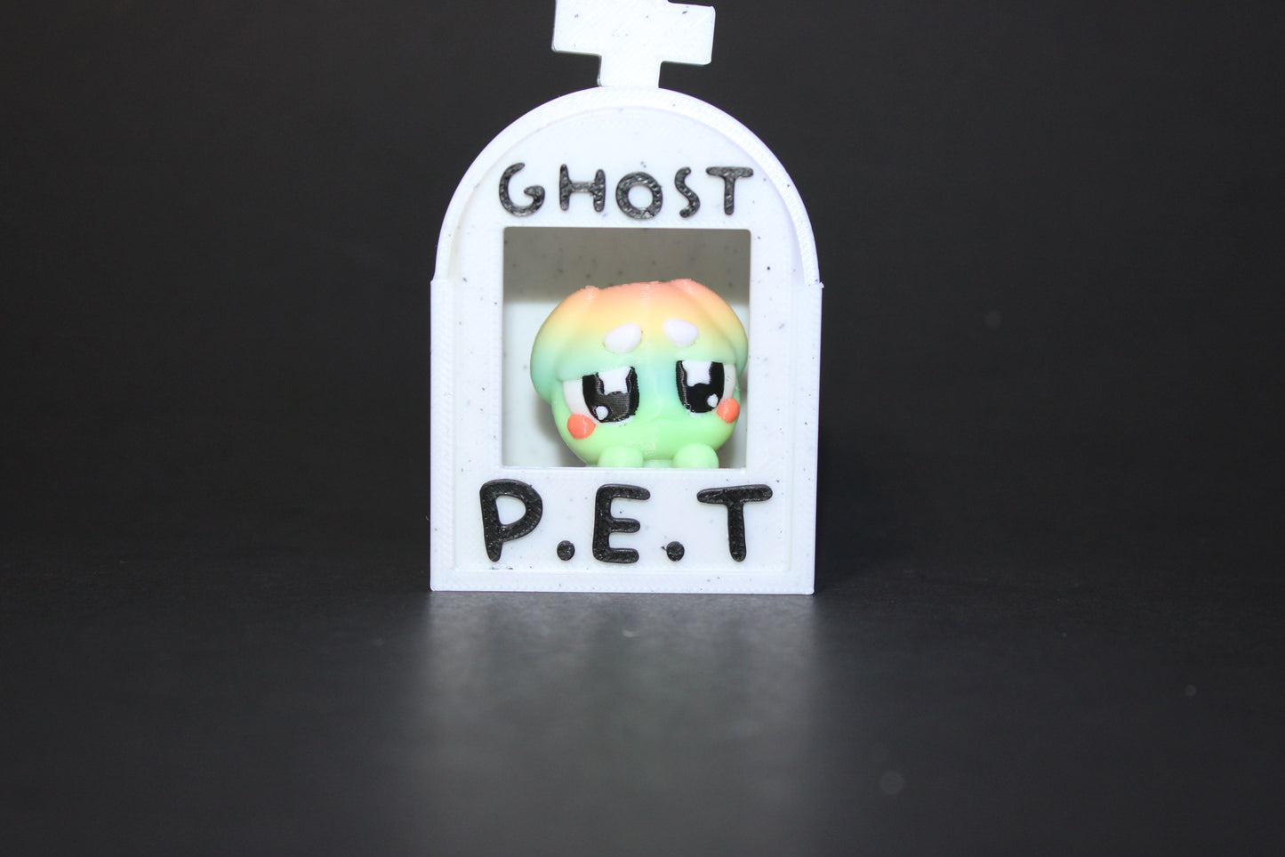3D-printed glow-in-the-dark or blacklight ghost pets, complete with a tombstone accessory. - Wonderland 3D Printing