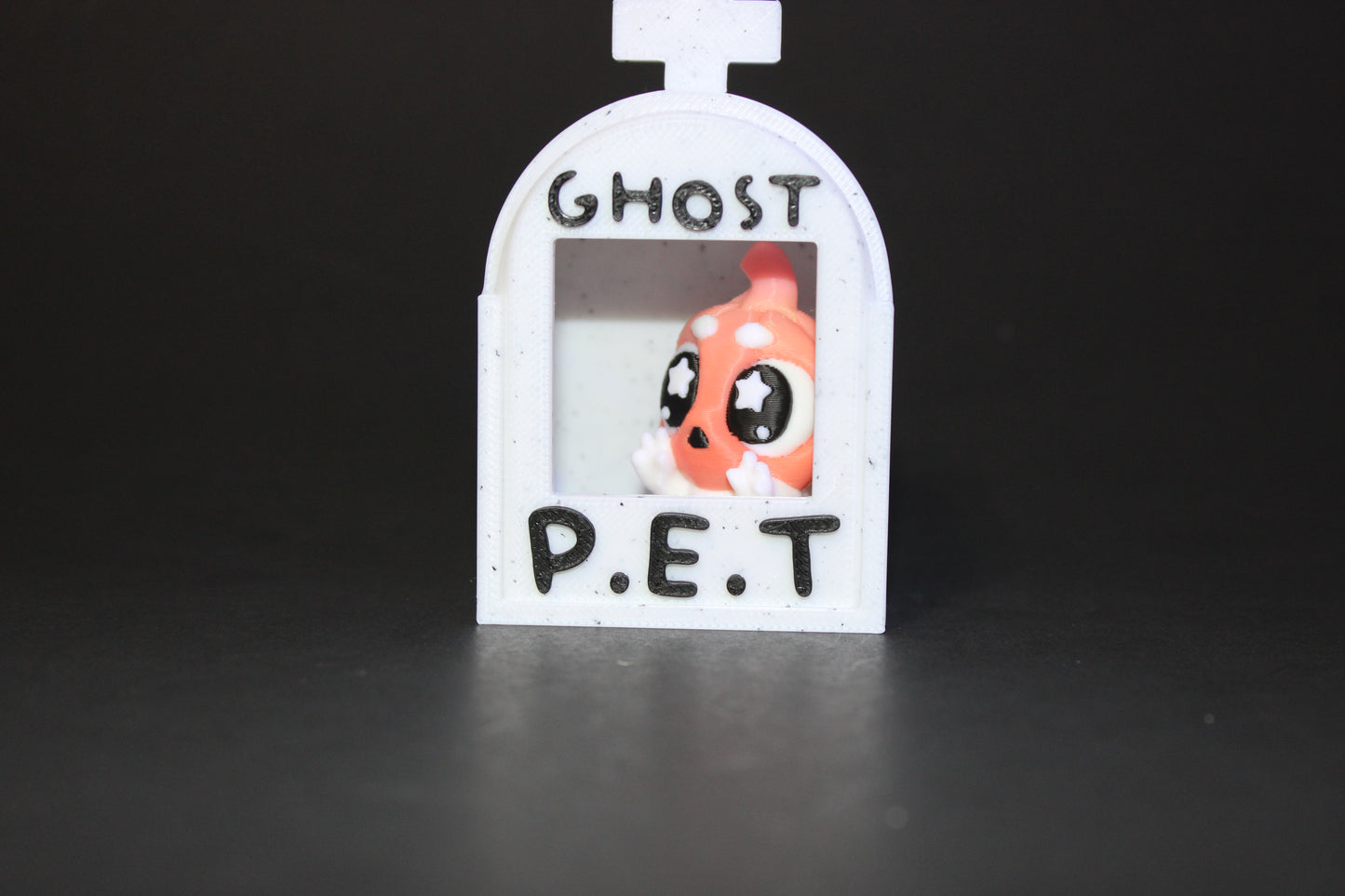 3D-printed glow-in-the-dark or blacklight ghost pets, complete with a tombstone accessory. - Wonderland 3D Printing