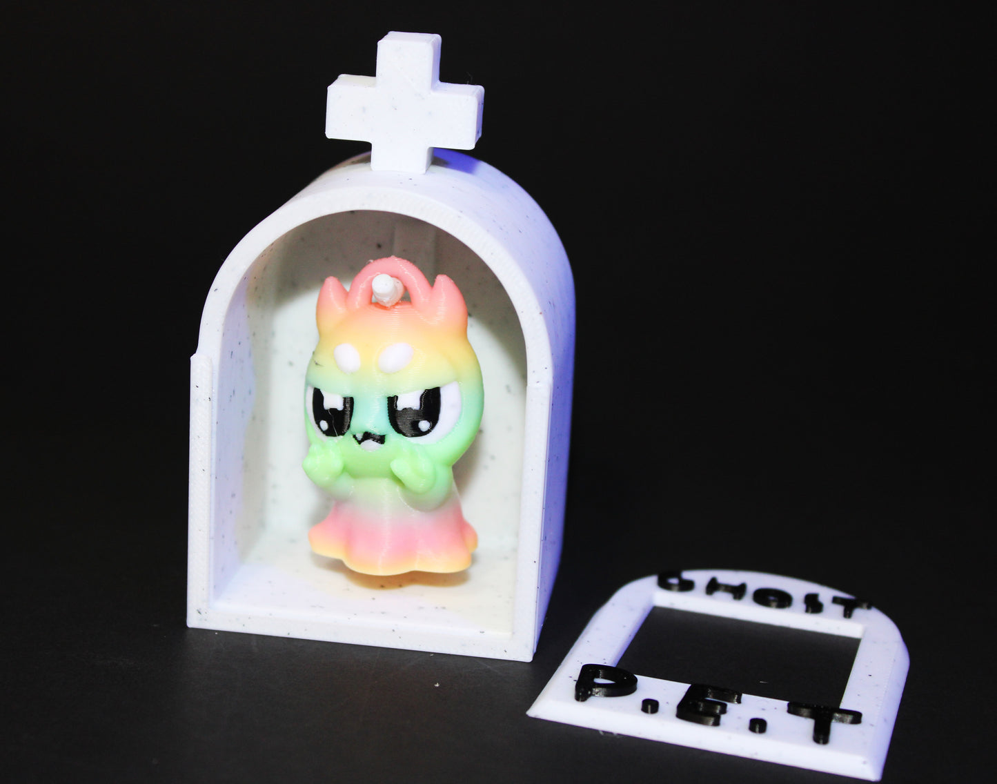 3D-printed glow-in-the-dark or blacklight ghost pets, complete with a tombstone accessory. - Wonderland 3D Printing