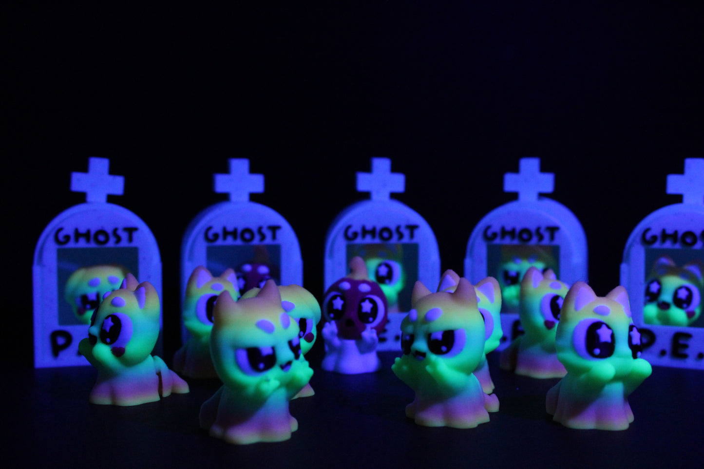 3D-printed glow-in-the-dark or blacklight ghost pets, complete with a tombstone accessory. - Wonderland 3D Printing