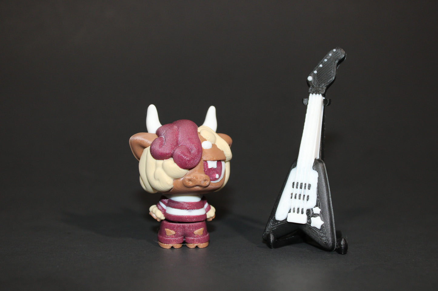 3D-printed Flexi Emo Cow with Guitar 2" Tall - Wonderland 3D Printing