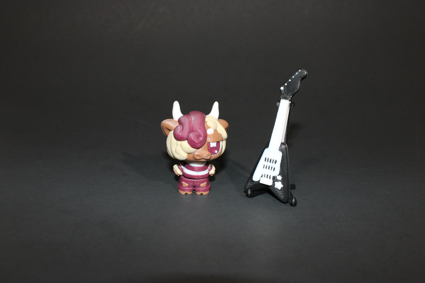 3D-printed Flexi Emo Cow with Guitar 2" Tall - Wonderland 3D Printing