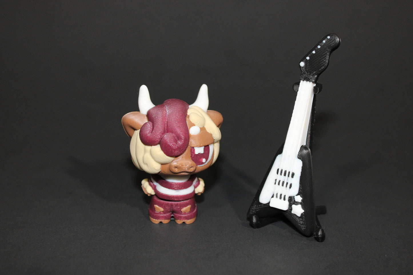 3D-printed Flexi Emo Cow with Guitar 2" Tall - Wonderland 3D Printing