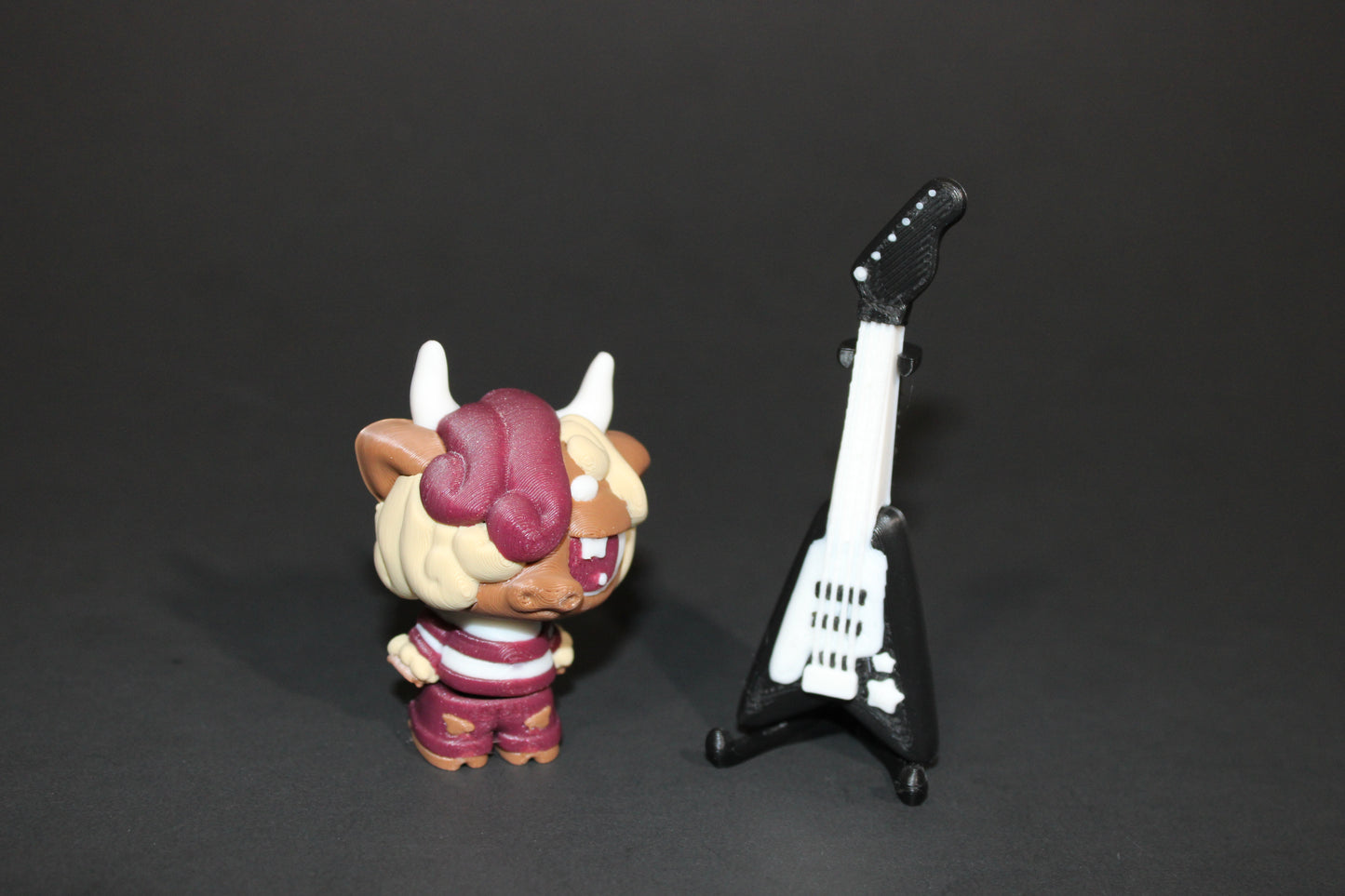 3D-printed Flexi Emo Cow with Guitar 2" Tall - Wonderland 3D Printing
