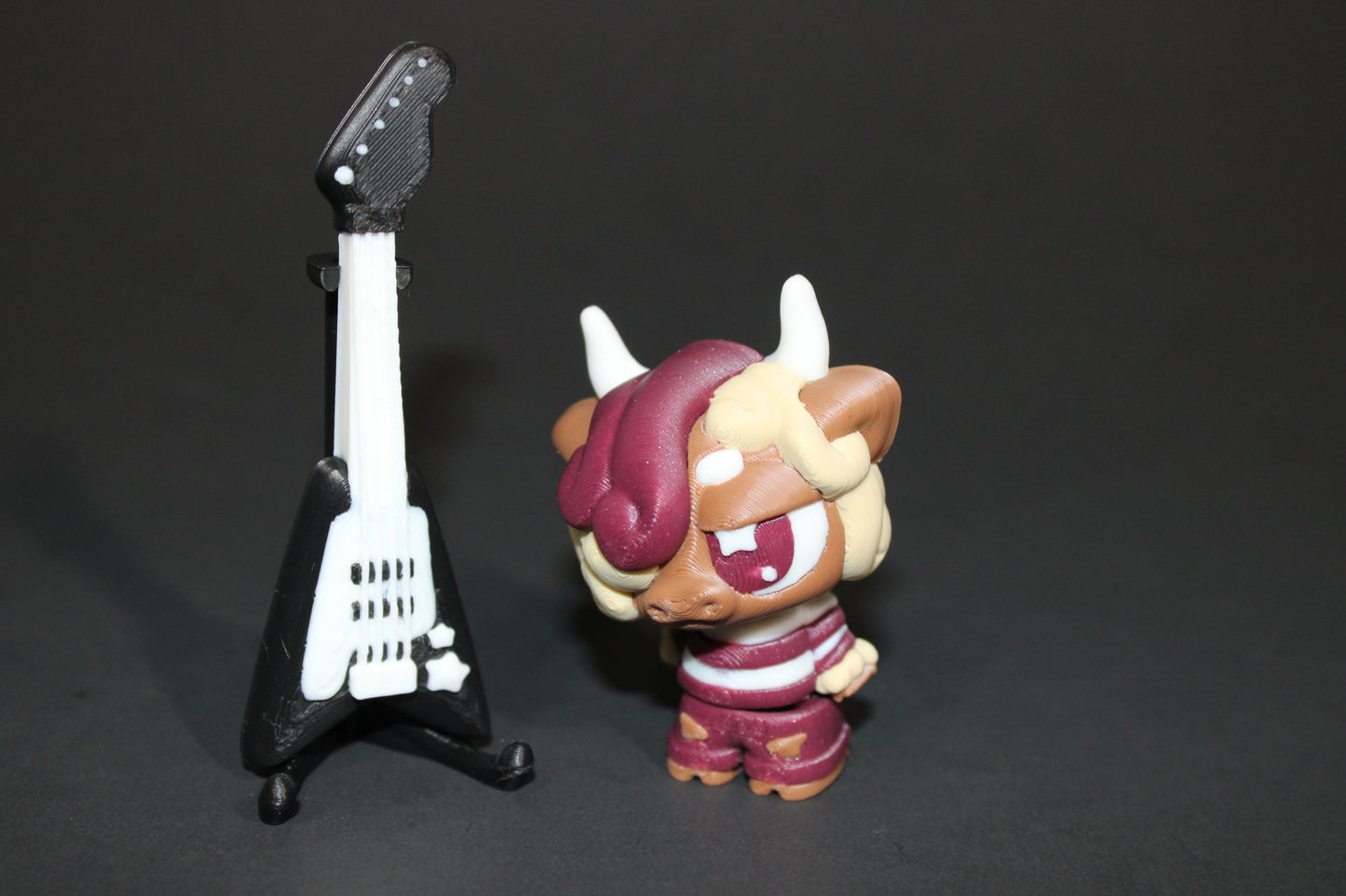 3D-printed Flexi Emo Cow with Guitar 2" Tall - Wonderland 3D Printing