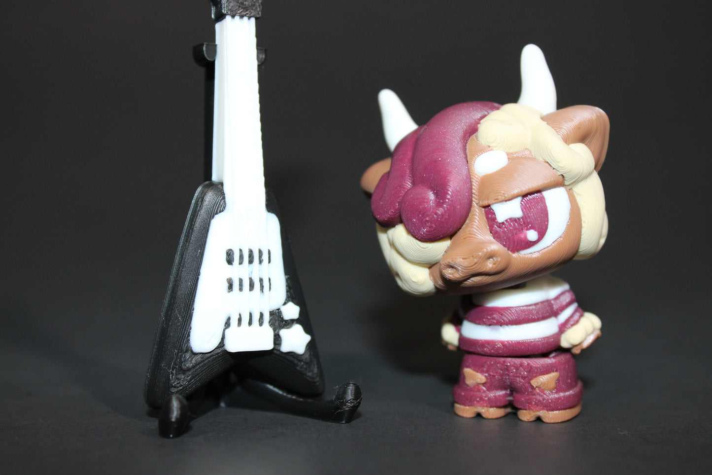 3D-printed Flexi Emo Cow with Guitar 2" Tall - Wonderland 3D Printing