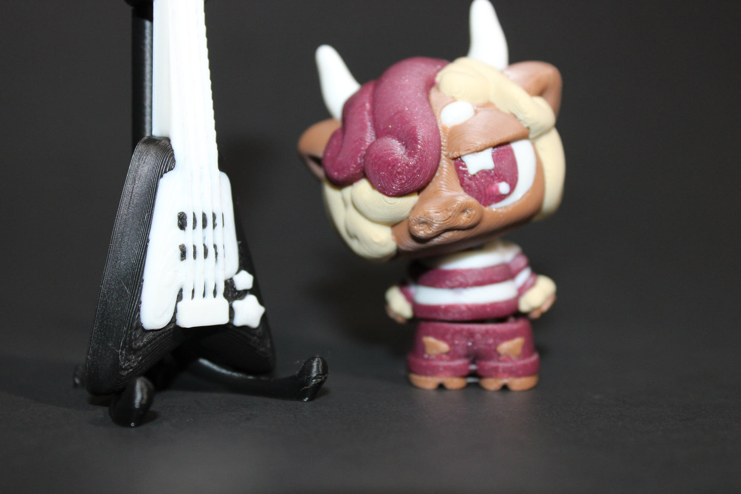 3D-printed Flexi Emo Cow with Guitar 2" Tall - Wonderland 3D Printing