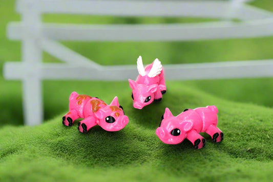 Three pink toy triceratops on a white background with green leaf patterns.