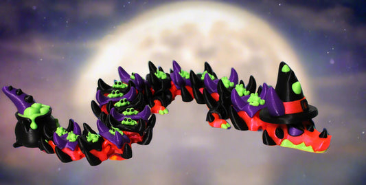 Halloween-themed toy arch with witch hats against a moonlit sky