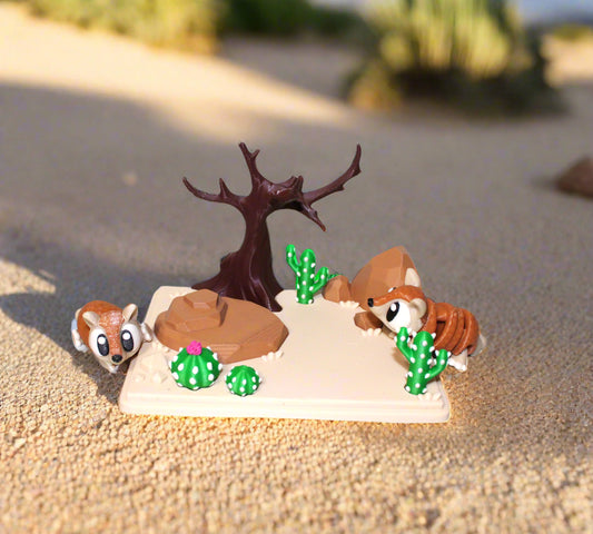 Small desert-themed diorama with animals and plants on a white background