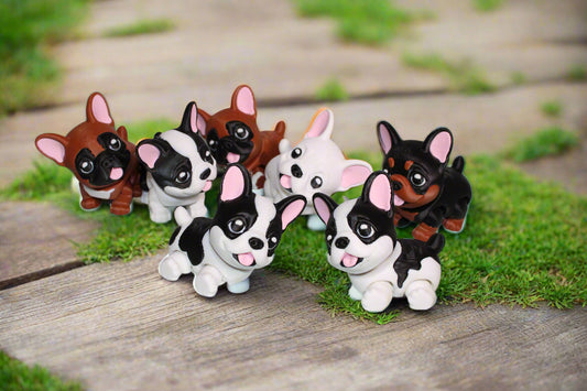 Set of small dog figurines on a light background with leaf patterns