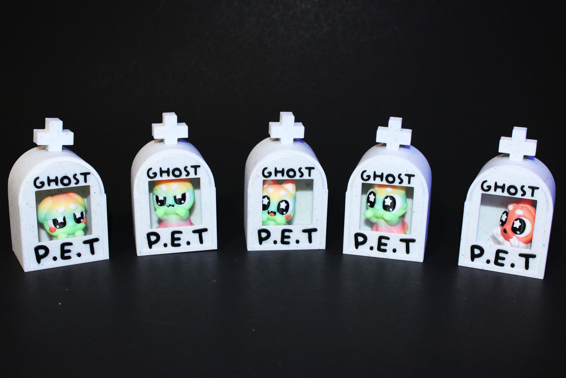 3D-printed glow-in-the-dark or blacklight ghost pets, complete with a tombstone accessory. - Wonderland 3D Printing 