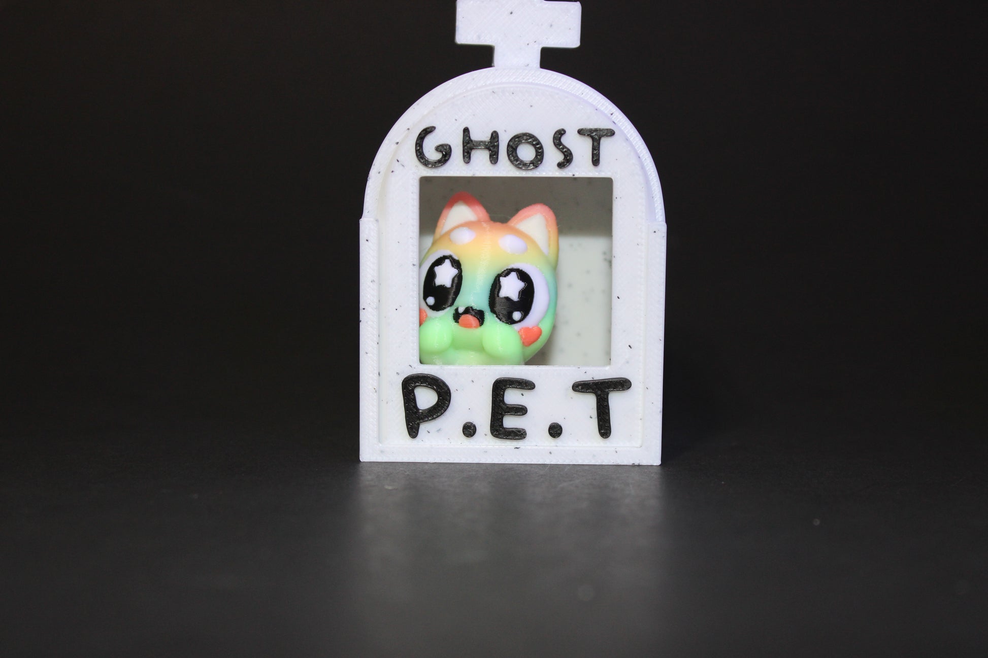 3D-printed glow-in-the-dark or blacklight ghost pets, complete with a tombstone accessory. - Wonderland 3D Printing 