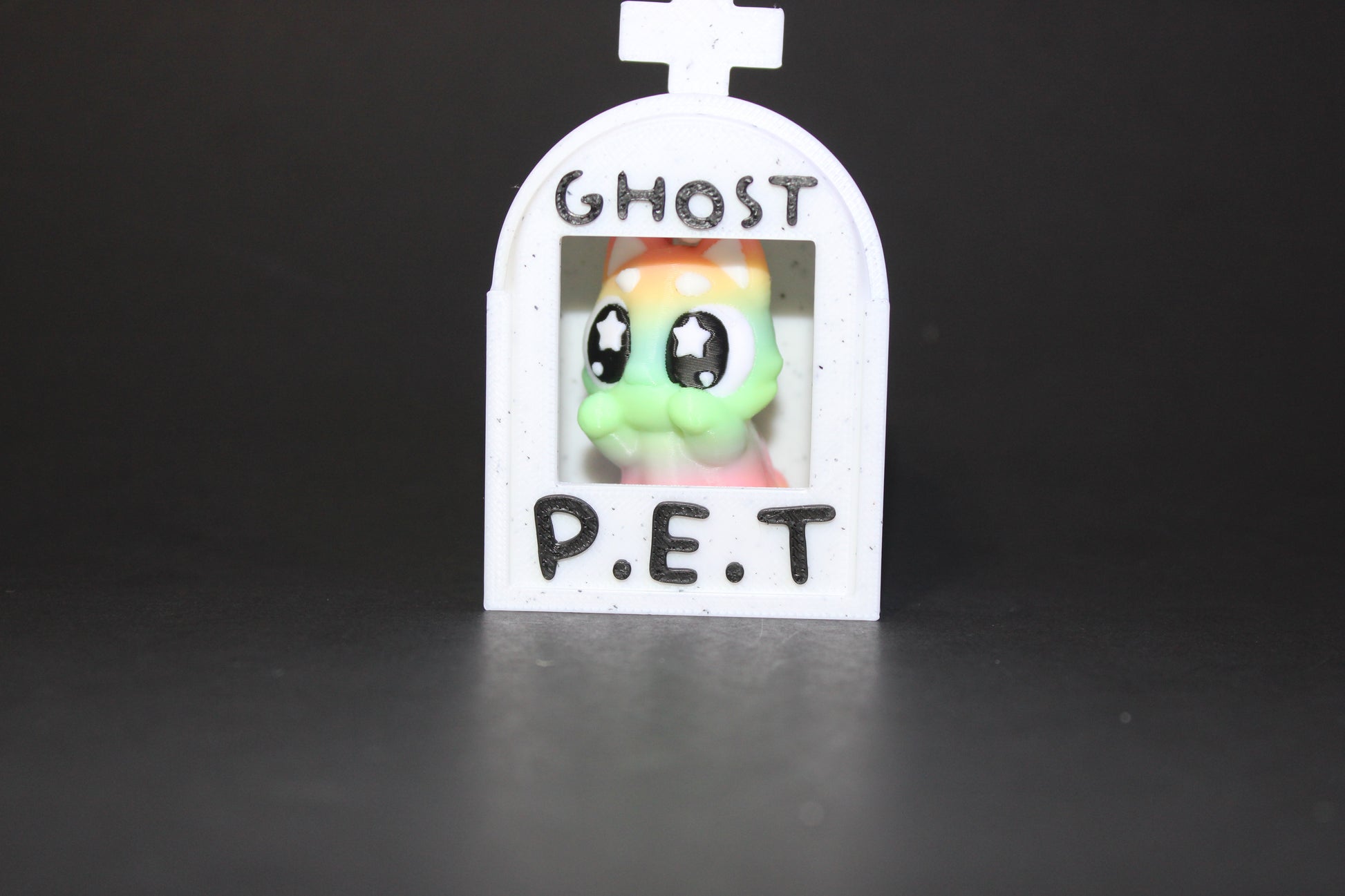 3D-printed glow-in-the-dark or blacklight ghost pets, complete with a tombstone accessory. - Wonderland 3D Printing 