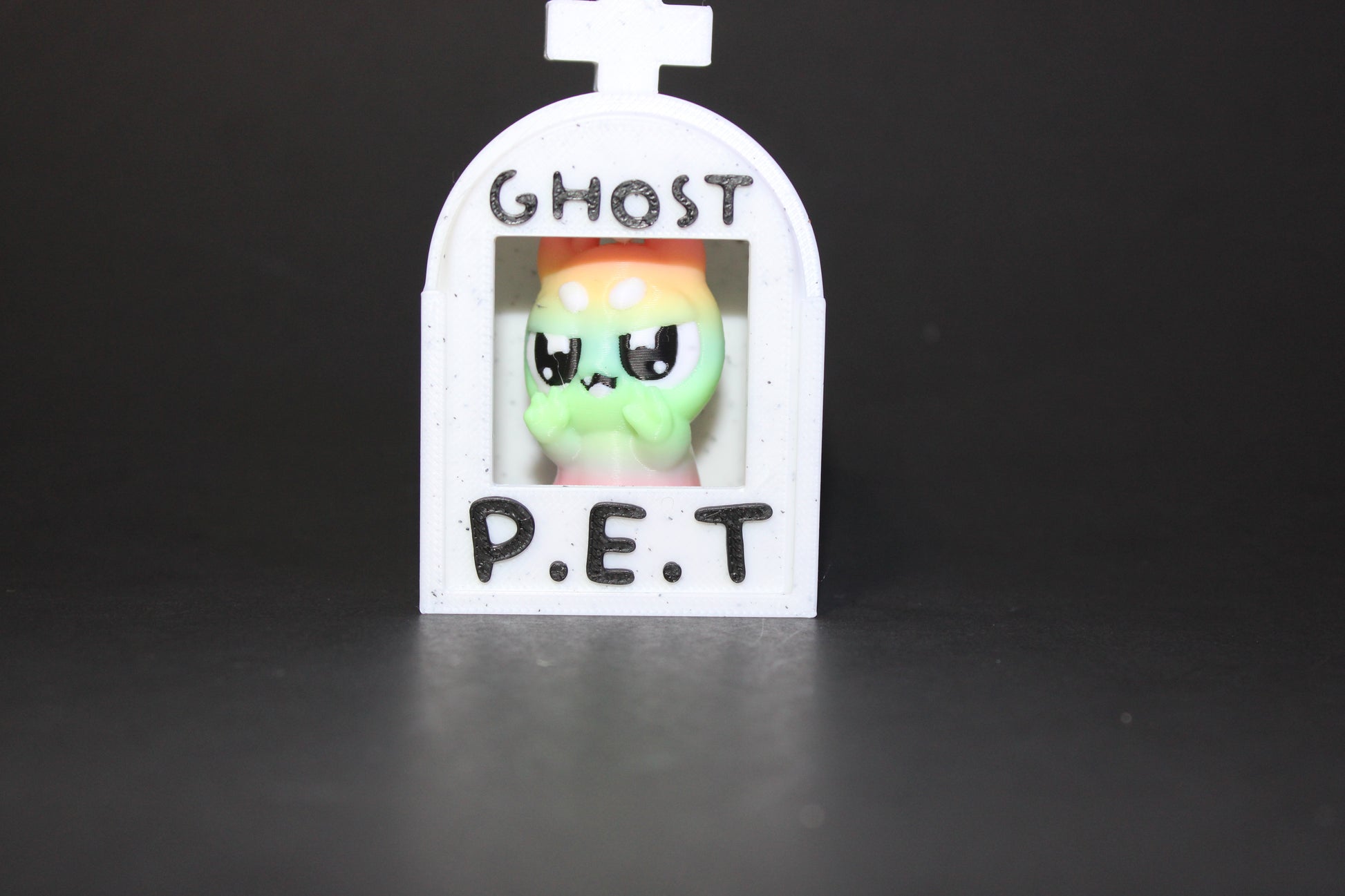 3D-printed glow-in-the-dark or blacklight ghost pets, complete with a tombstone accessory. - Wonderland 3D Printing 