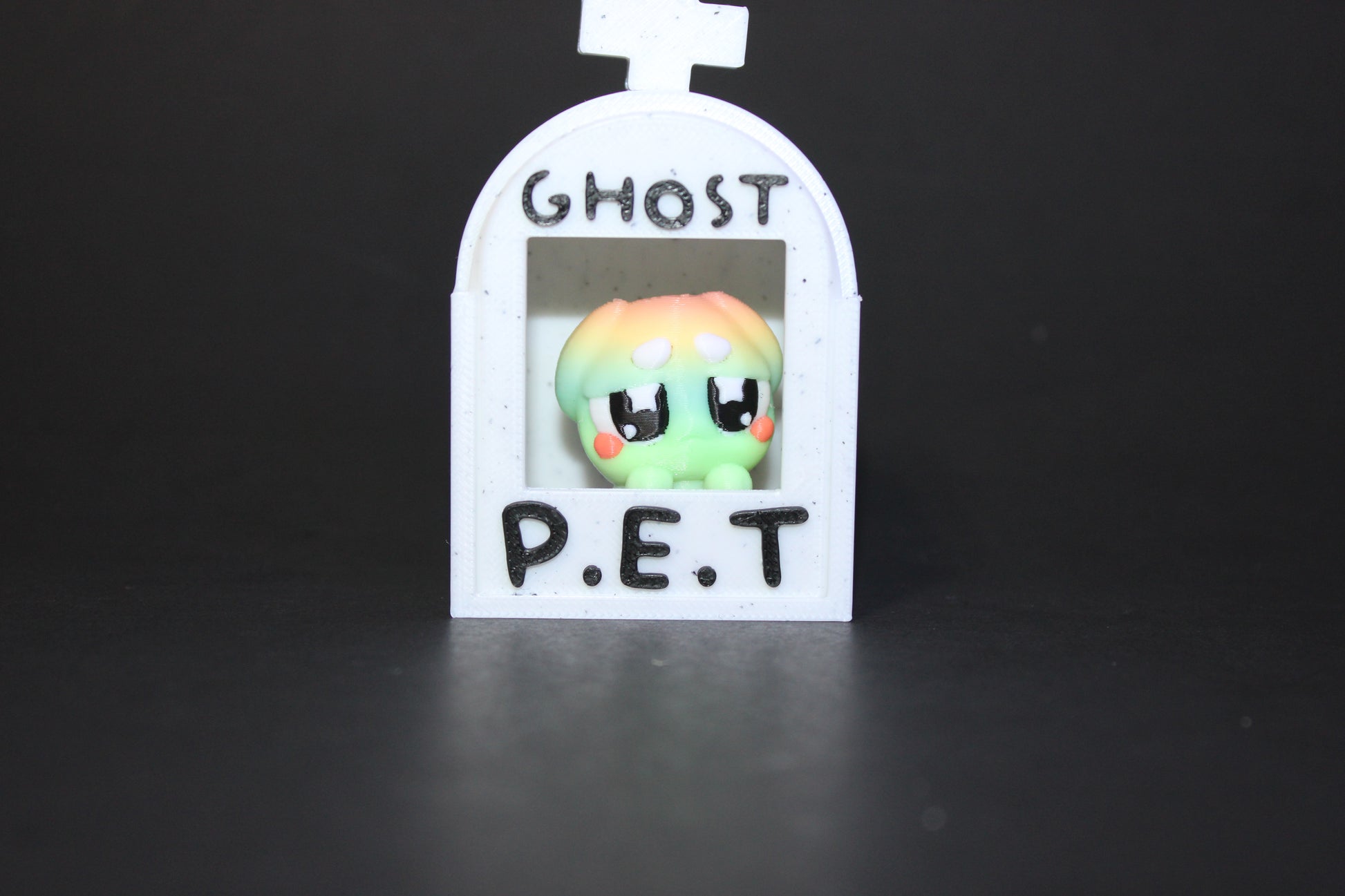 3D-printed glow-in-the-dark or blacklight ghost pets, complete with a tombstone accessory. - Wonderland 3D Printing 