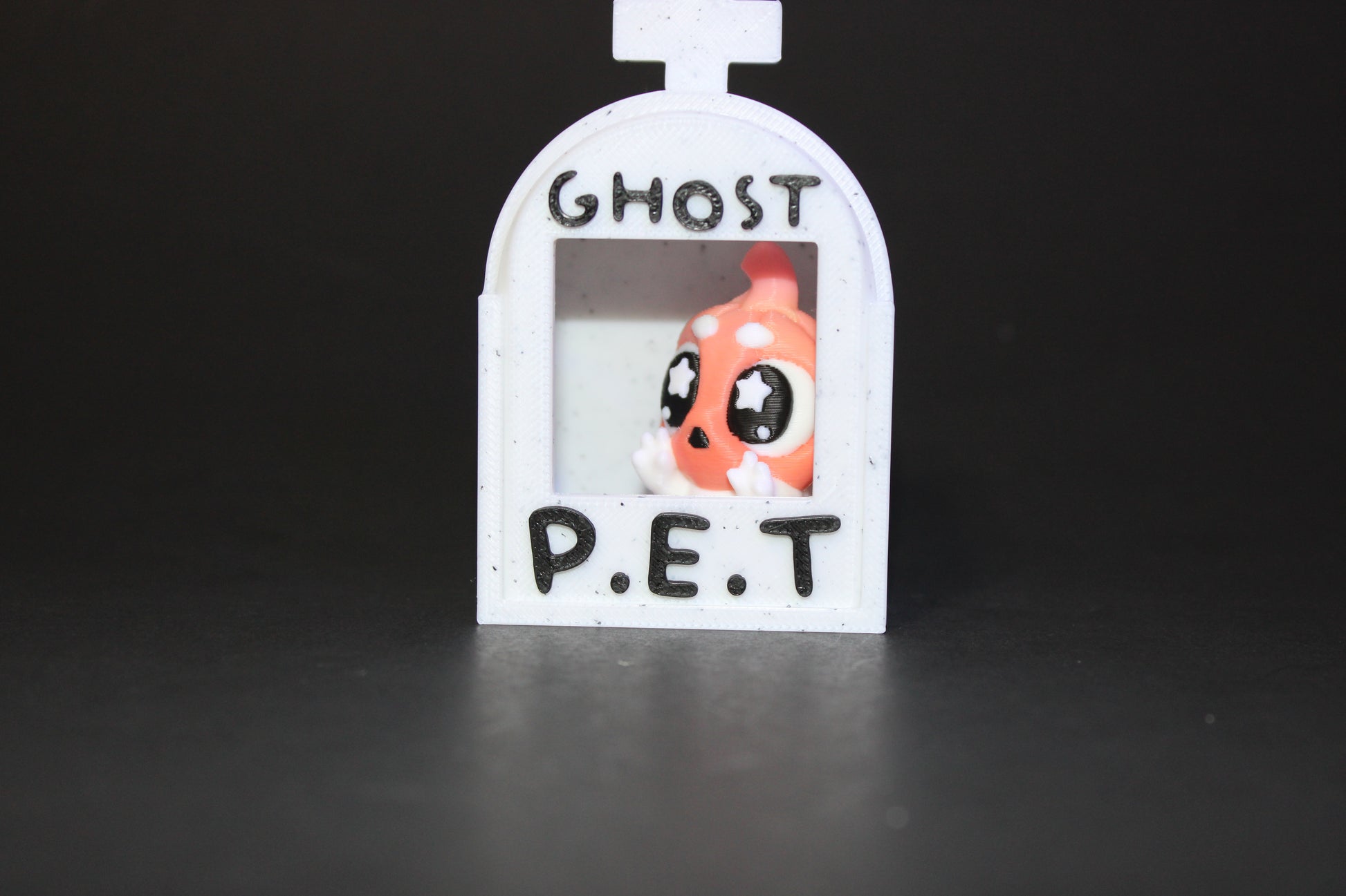 3D-printed glow-in-the-dark or blacklight ghost pets, complete with a tombstone accessory. - Wonderland 3D Printing 