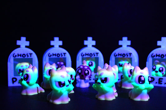 3D-printed glow-in-the-dark or blacklight ghost pets, complete with a tombstone accessory. - Wonderland 3D Printing 