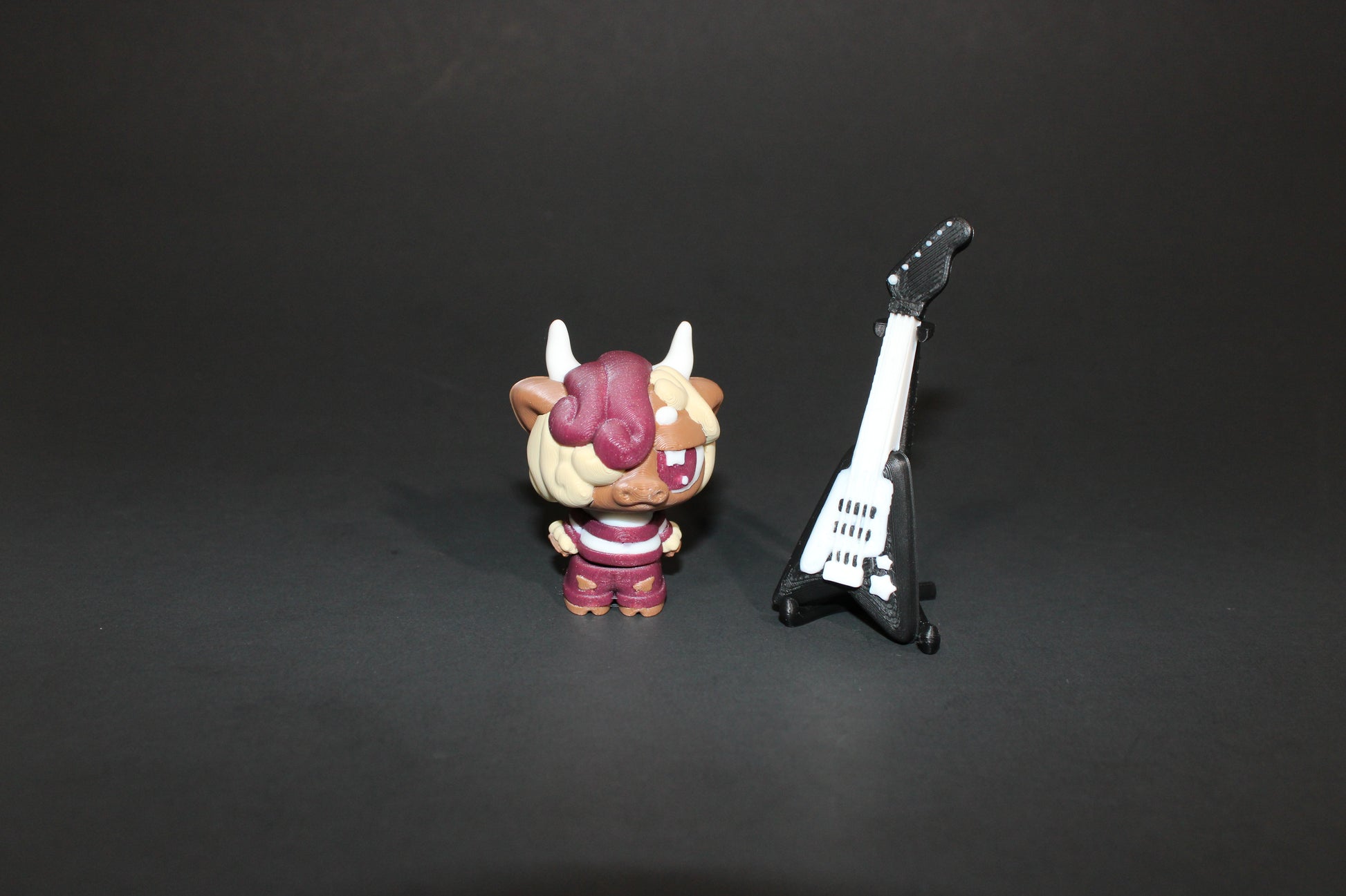 3D-printed Flexi Emo Cow with Guitar 2" Tall - Wonderland 3D Printing 
