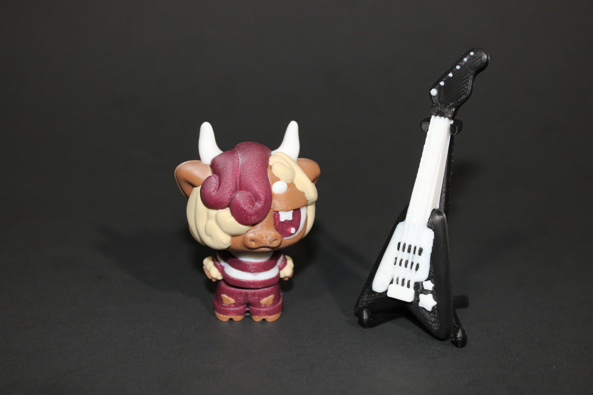3D-printed Flexi Emo Cow with Guitar 2" Tall - Wonderland 3D Printing 