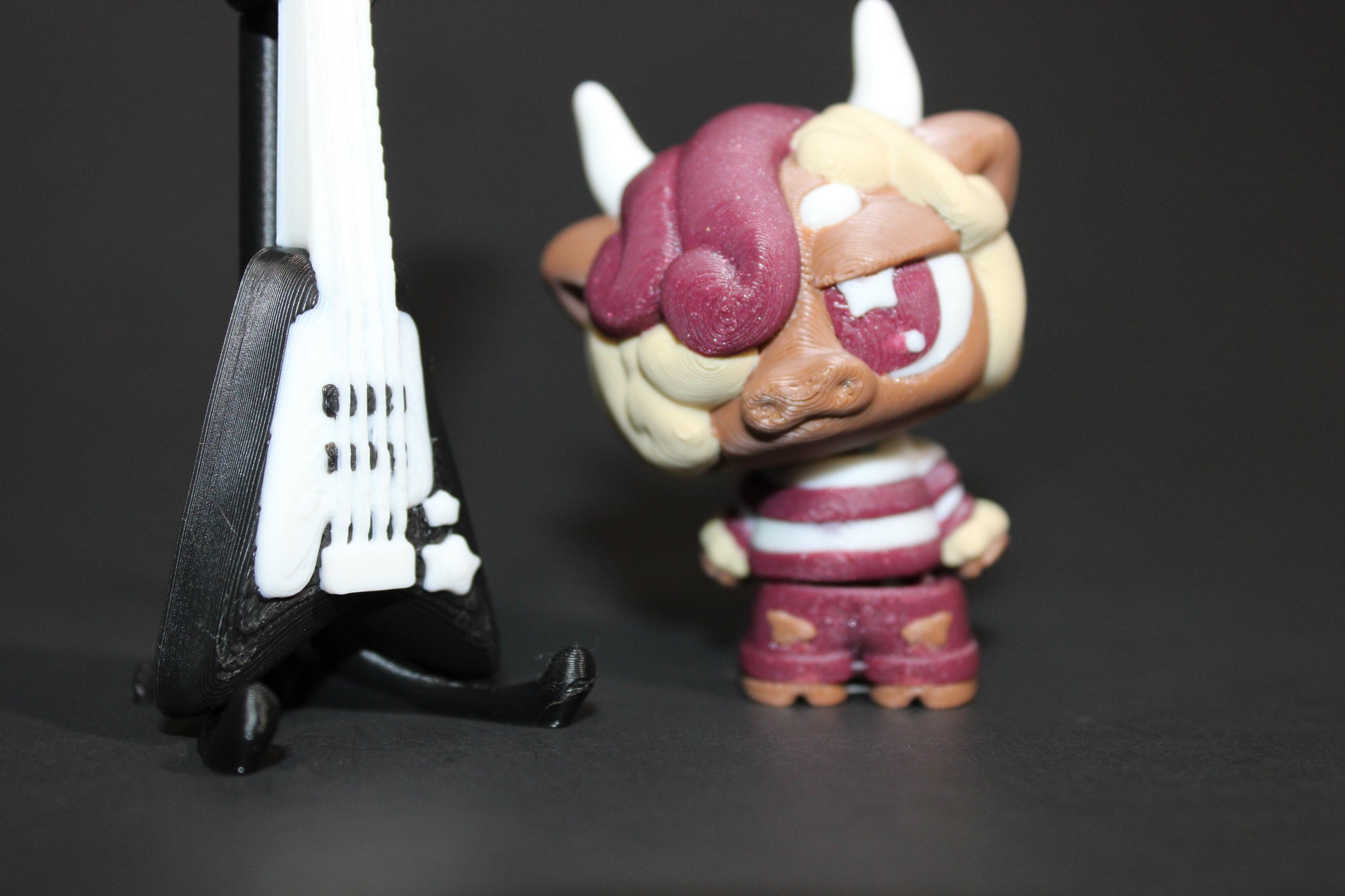 3D-printed Flexi Emo Cow with Guitar 2" Tall - Wonderland 3D Printing 